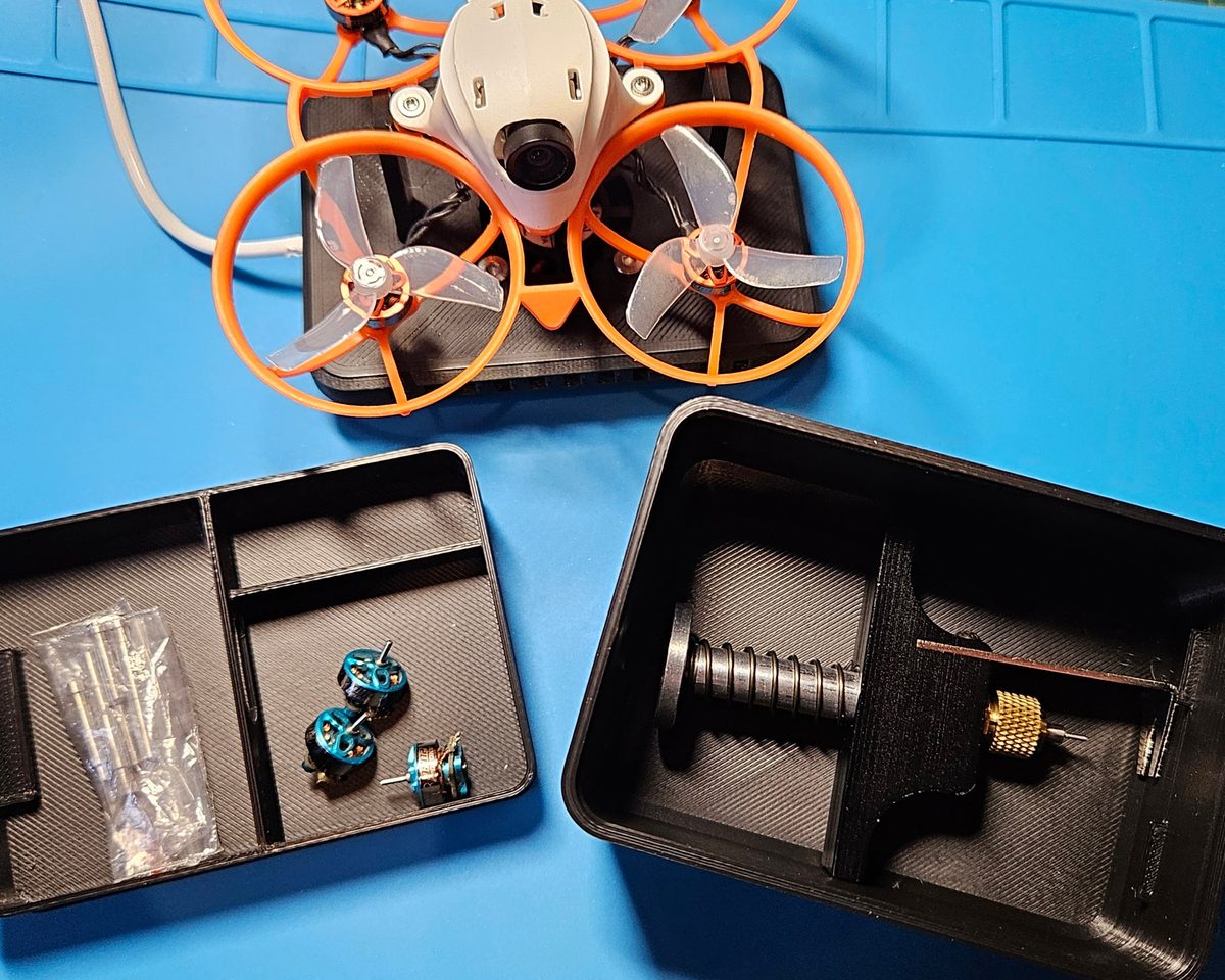 Open Whoop Workbench Box showing the divided tray and the whoop holder
