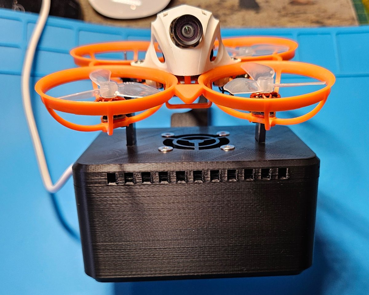 BetaFPV whoop clipped onto the Whoop Workbench Box with the fan mount in the lid